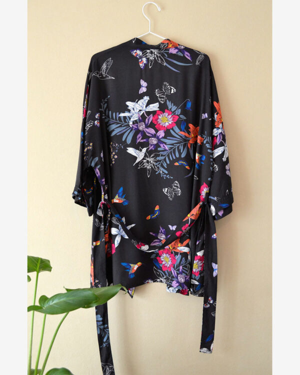kimono with floral print hanging on the wall